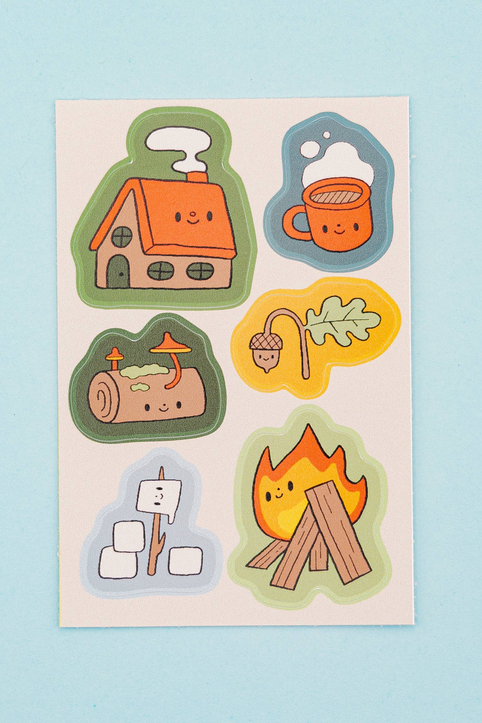 Set of camping-themed stickers on a light blue background