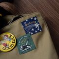 Two woven patches shown on a canvas tote bag