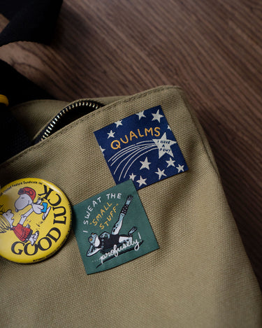Two woven patches shown on a canvas tote bag