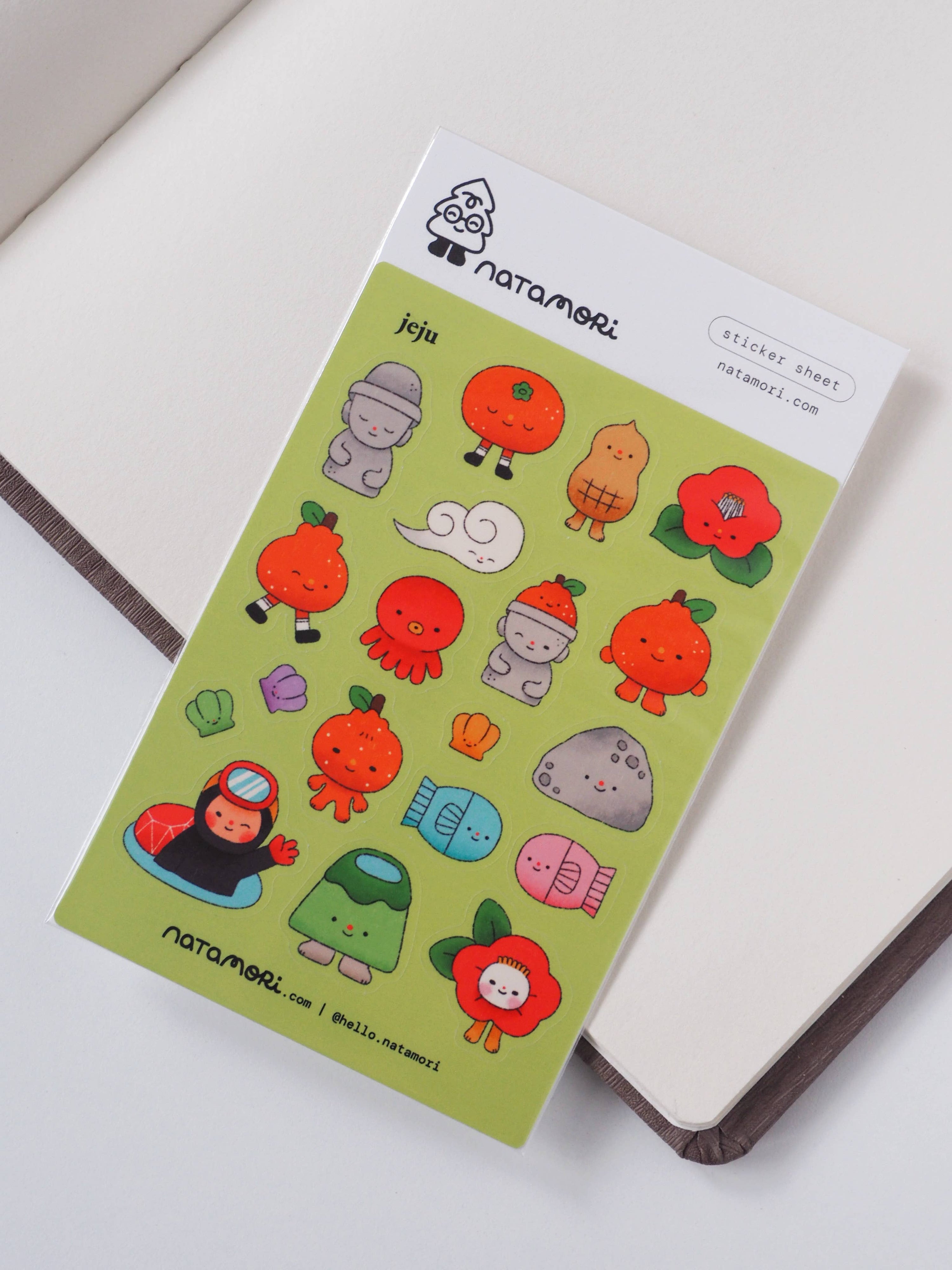Sticker sheet with cute character designs on a green background, featuring the brand 'natamori'.