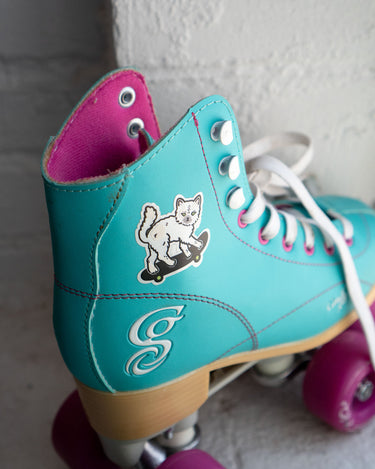 Reflective sticker of a cute cat on a skateboard shown stuck to a child's rollerskate