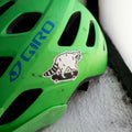 Reflective sticker of a cute raccoon on a skateboard shown on a kids bike helmet