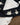 Close-up of a black long-sleeved tee with white swan designs 