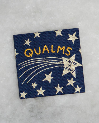 Navy blue patch featuring a star design and the text "Qualms - I have a few!"