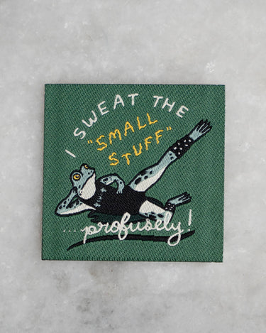 Patch with woven image of a frog in workout gear and the phrase "I sweat the small stuff - profusely!"